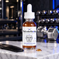 TheLooksMaxxing Hair & Beard Peptide Serum amber dropper bottle on a marble plinth in a dark gym